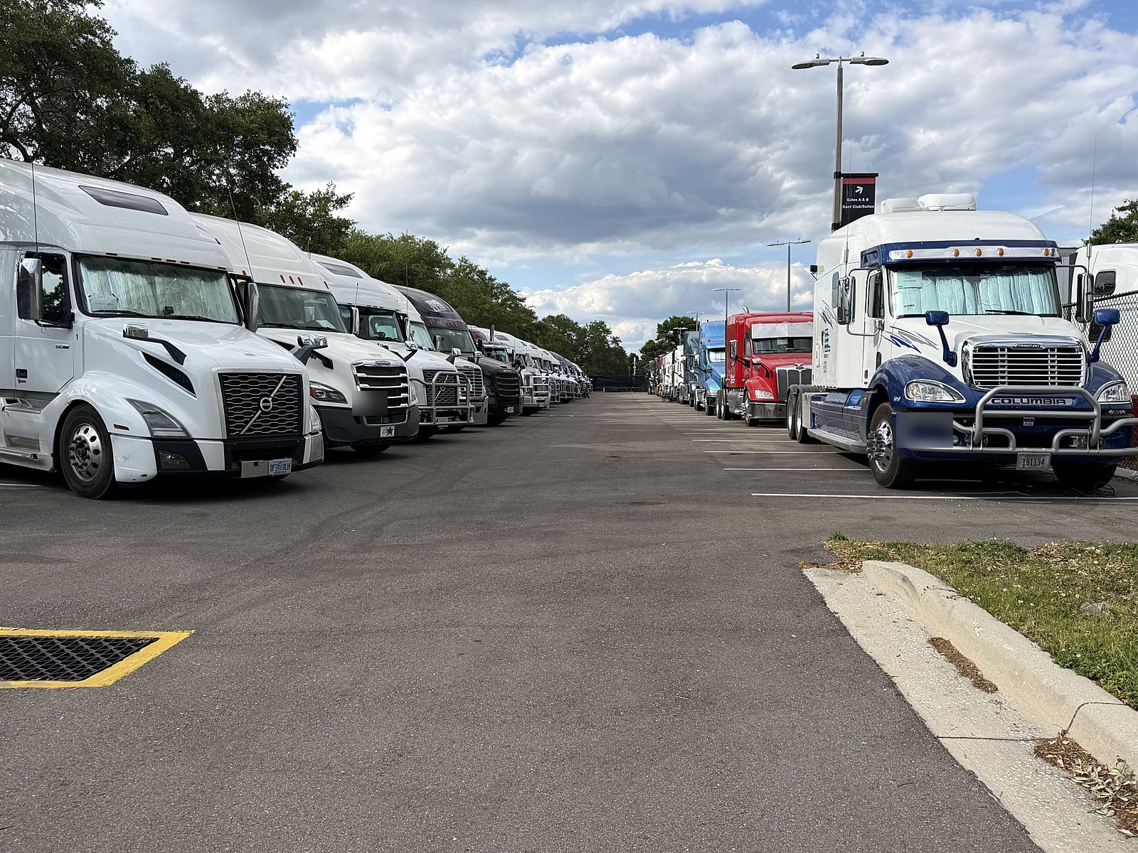 Rows of tractors and trailers in a yard